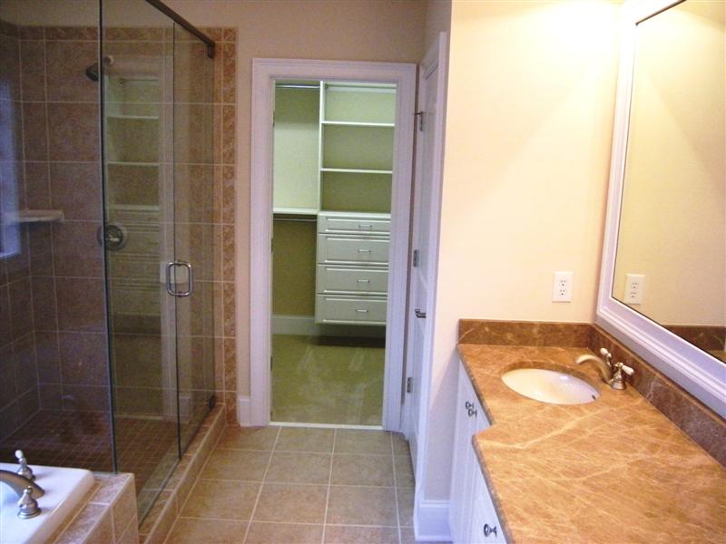 Luxurious master bath has a huge walk-in closet with built-ins