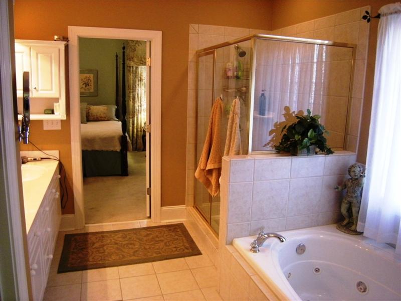 Walk-in shower and jetted whirlpool tub round out this luxurious master bath