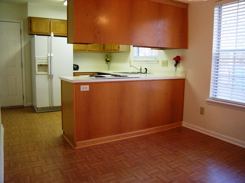 Eat-in kitchen has wood cabinets and, new flooring and an included refrigerator