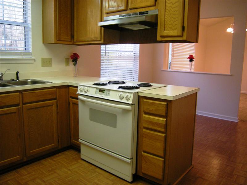 White appliances include an electric cooktop and oven