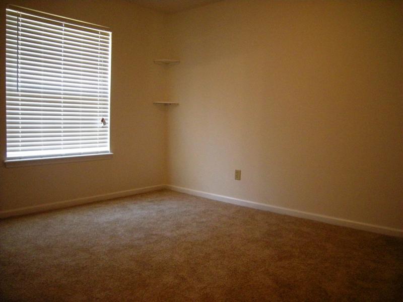 Spacious master bedroom has wall-to-wall carpet and fresh paint