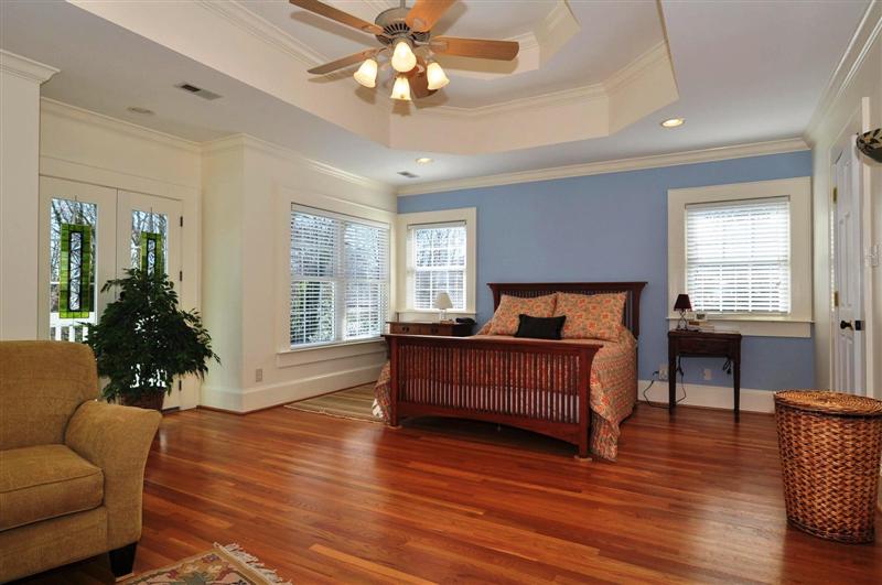 Master suite is huge with a sitting area, trey ceiling, wood floors and access to a
