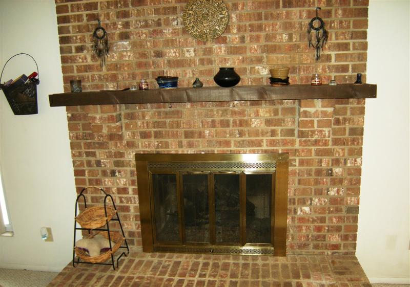 Solid brick fireplace with gas logs