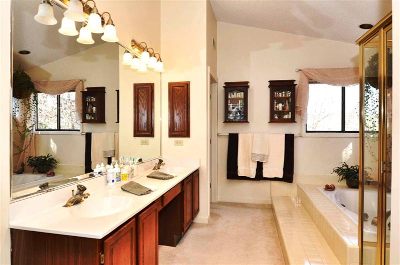 Luxurious master bath has a dual vanity, ornate tile and a HUGE walk-in closet
