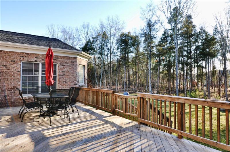 Wood deck overlooks the well landscaped backyard; home is on over an acre and is in a cul-de-sac \