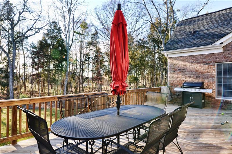 Wood deck overlooks the well landscaped backyard; home is on over an acre and is in a cul-de-sac