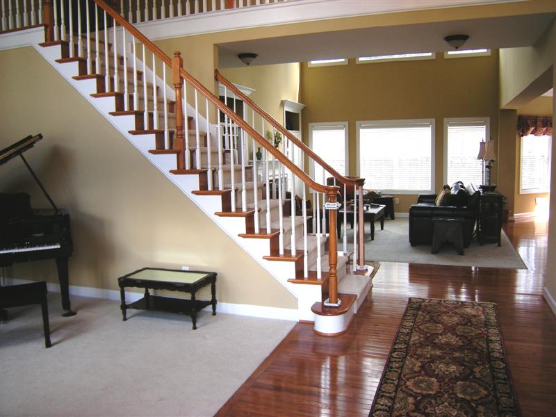 Foyer, staircase and carpeted living room
