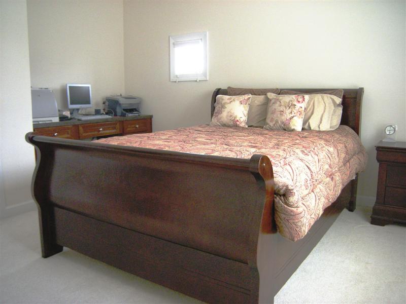 Spacious guest bedroom on the main level has ample closet space and desk area