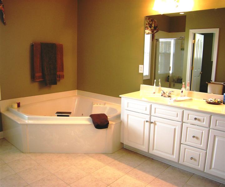 Luxurious master bathroom has a dual vanity and designer tile