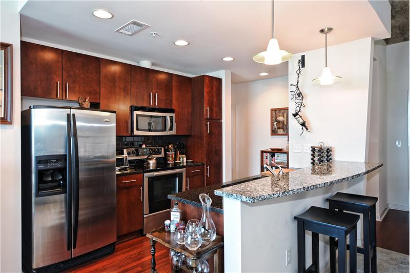 Kitchen has stainless steel appliances, granite countertops & beautiful cabinetry