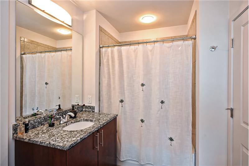 Master bathroom has granite countertops & custom cabinetry