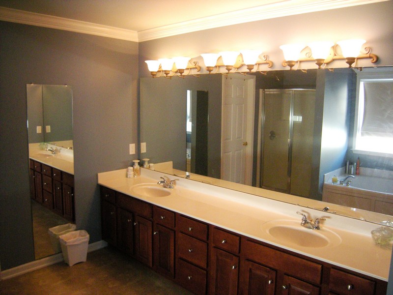 Master bathroom has a dual vanity and glass-enclosed walk-in shower