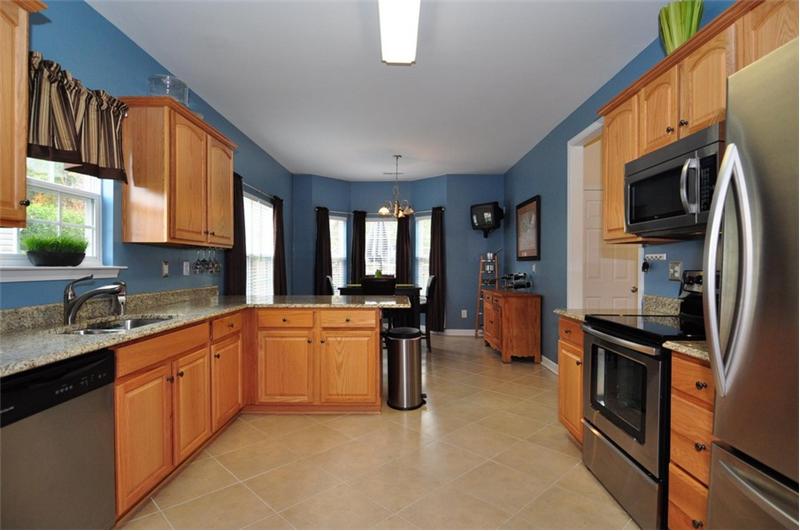 The gourmet kitchen has designer paint and all stainless steel appliances