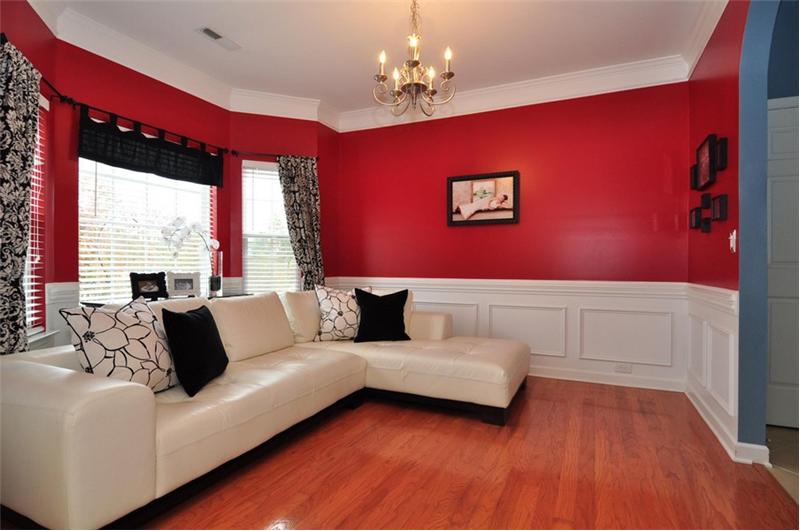 The spacious living room off the foyer has beautiful hardwoods