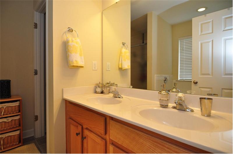 Master bathroom has dual vanities and custom cabinetry