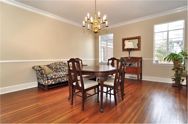 The enormous dining room has beautiful hardwoods and custom moldings