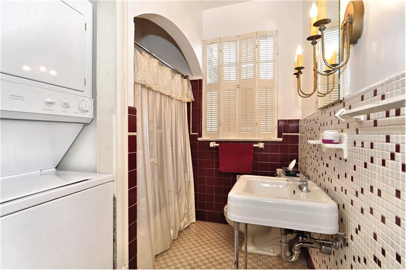 Full bathroom with included stackable washer & dryer