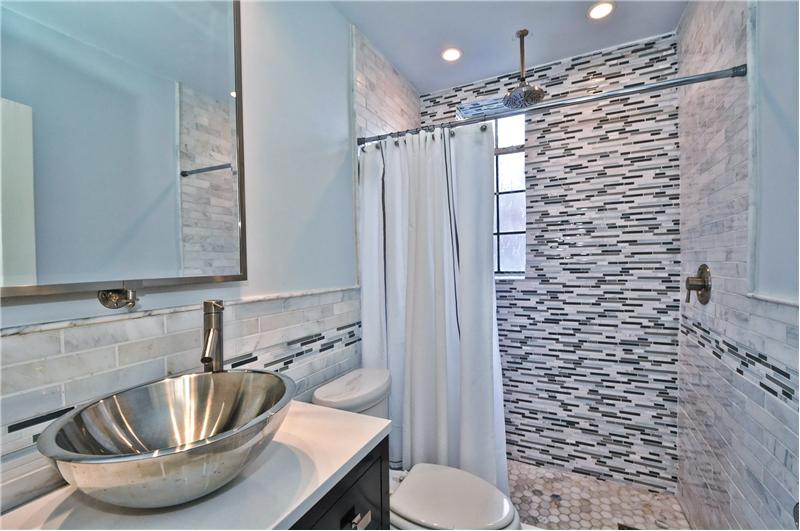 Gorgeous renovation of bathroom.  Lovely glass walk-in shower with vessel sink