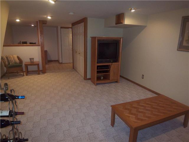 Large finished lower level w/ Berber carpet, separate office area