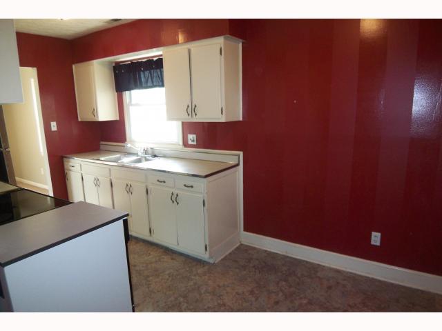 Large dining area in kitchen with decorator paint and white cabinets