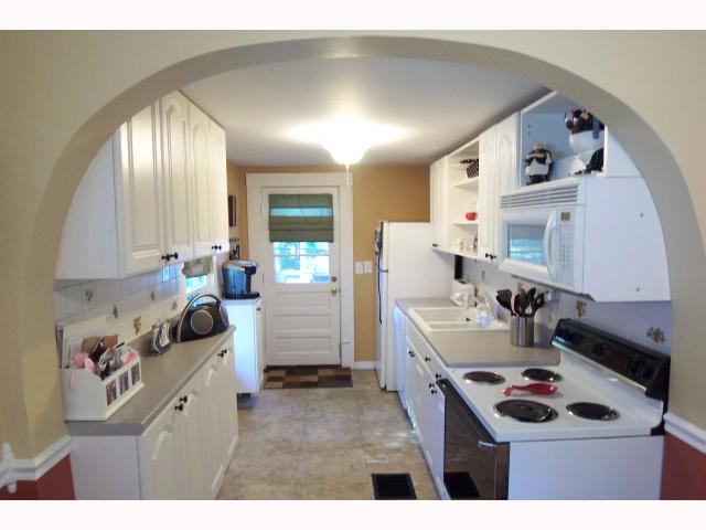 Kitchen:   Sun-filled Updated kitchen w/abundance of cabinets, newer dishwasher and built in microwave, new floor