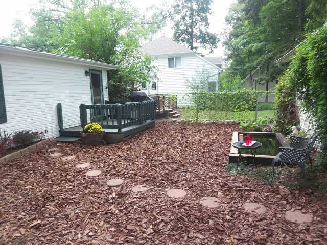 Yard/Garden:   Spacious privacy fenced yard with deck and pond, private access to large 2+ car garage