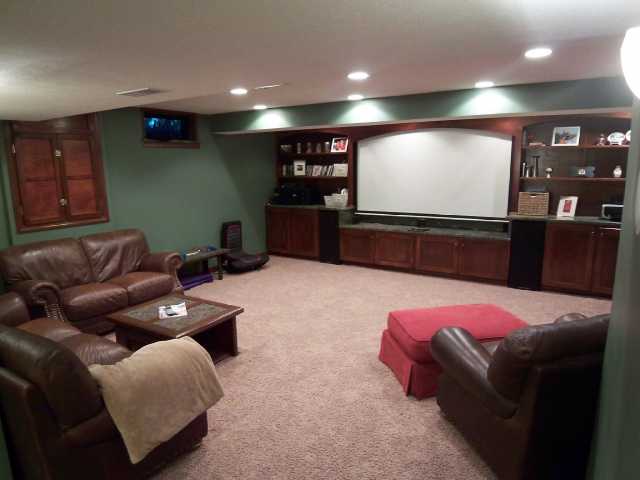 Lower level media room with custom built in- Projector Screen DOES NOT convey..
