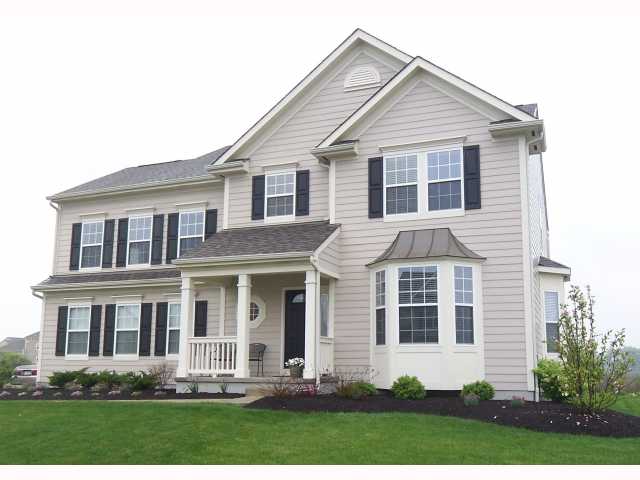 Exterior Front:  Beautiful professional landscape welcomes you to this spacious MI Burton home