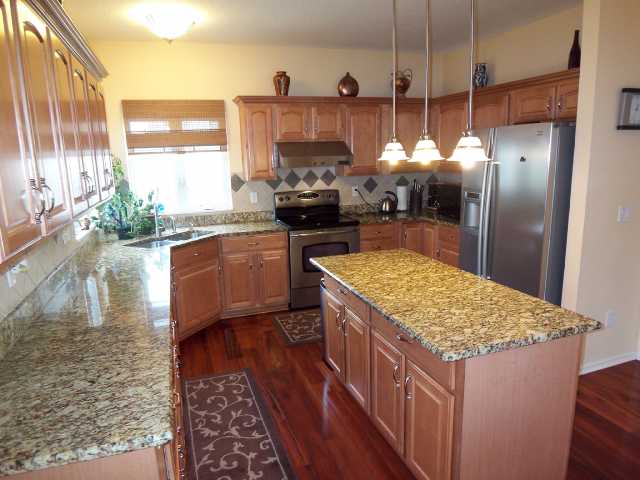 Kitchen:  Abundance of maple cabinets in this center island kitchen with granite countertops