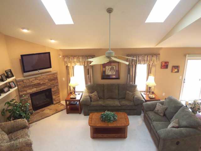 Den/Family/Great Room:  Sun splashed great room with vaulted ceiling great room, new carpet, custom stone front fire place