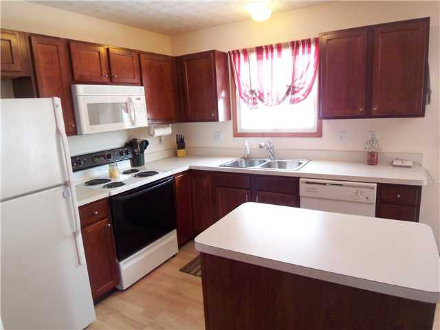 Kitchen:  Beautiful cherry cabinet center island kitchen- appliances remain