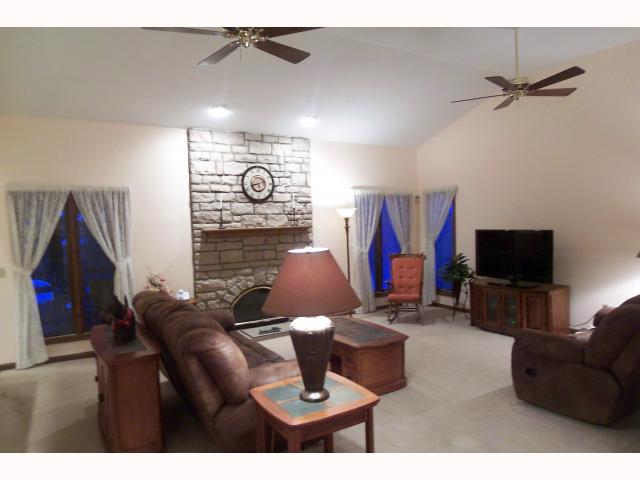 Den/Family/Great Room:  Open floor plan with vaulted ceilings offers floor to ceiling stone gas log fireplace
