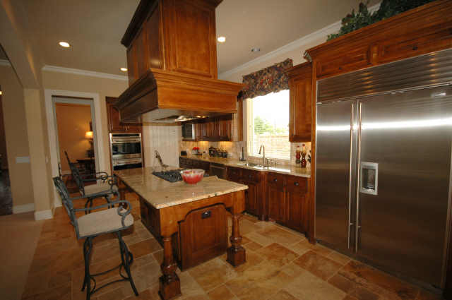 Another view of the kitchen which shows the Sub Zero refrigerator.