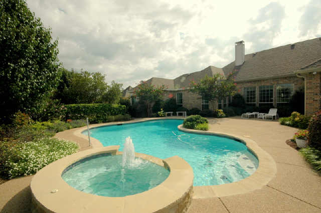 Another view of the pool and spa and back of home