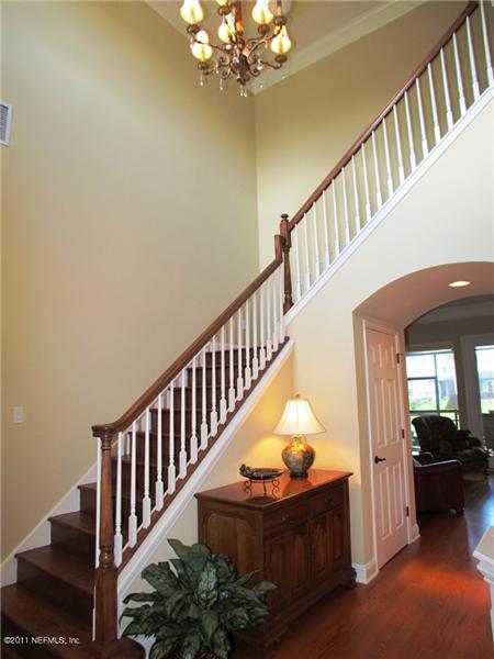 Grand hardwood staircase with hardwood treads are the focal point in the two-story Foyer
