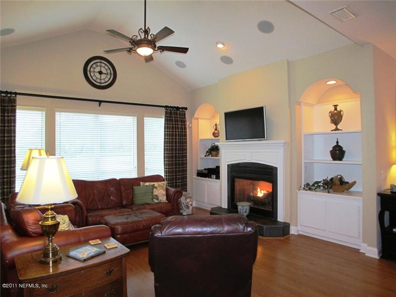 The custom fireplace with built-ins and vaulted ceiling make for a gorgeous Family Room with great views of the water