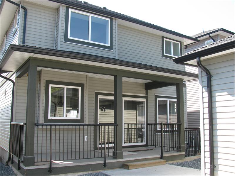 Covered back deck leading to the detached garage