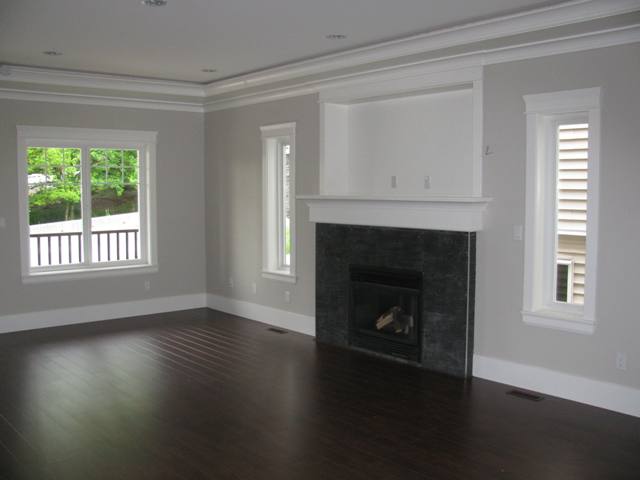 Great Room with laminate Floor, crown moulding and baseboard