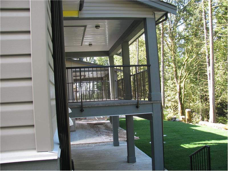 Exterior Back showing the backyard, deck, and greenbelt