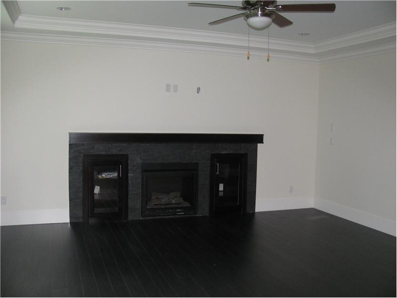 Family room with gas fireplace and ceiling fan