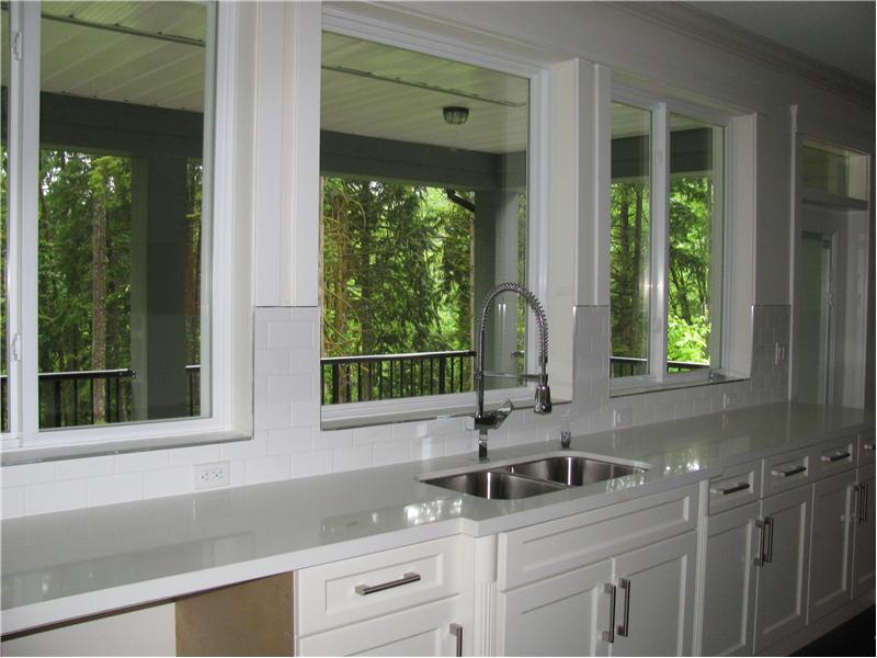 Kitchen showing the covered deck and greenbelt