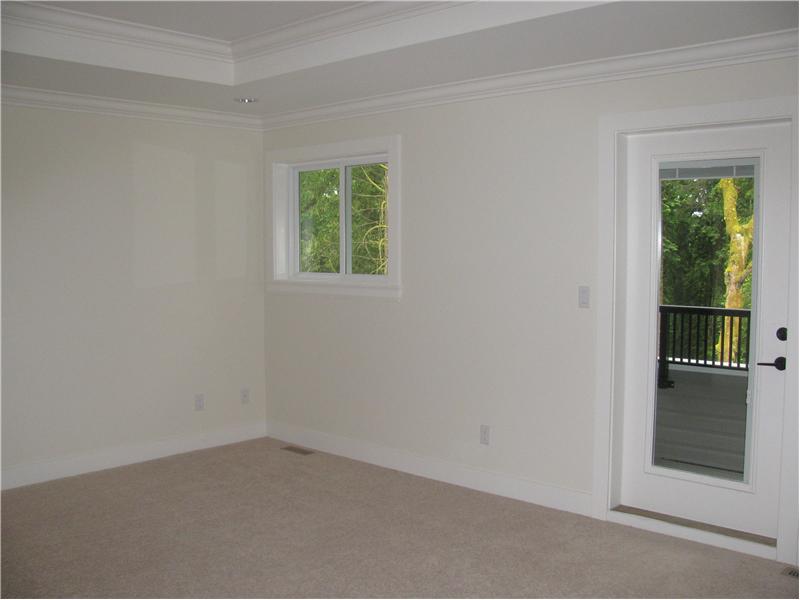 Master Bedroom with door leading to balcony overlooking the greenbelt