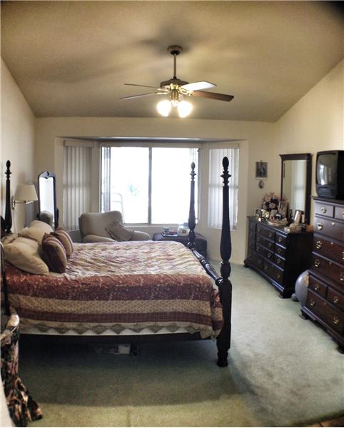 master bedroom with bay windows